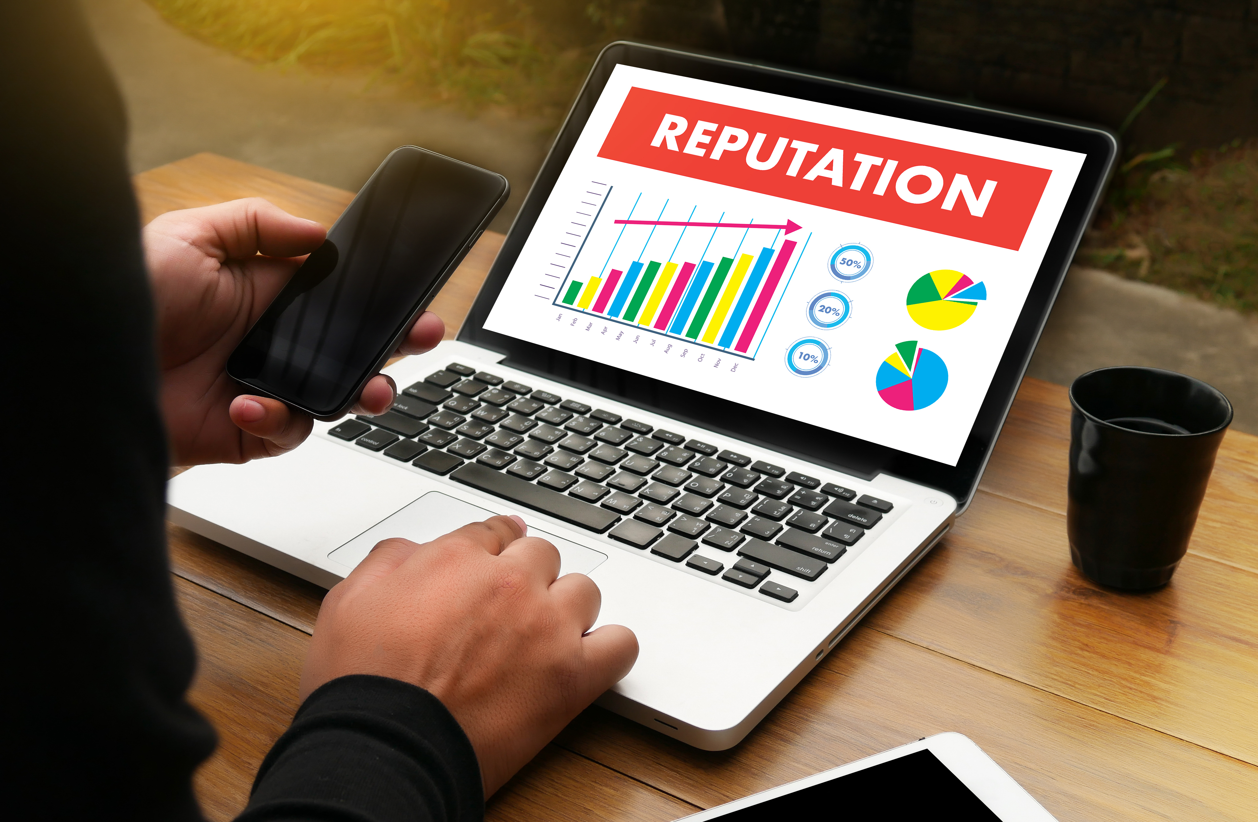 Laptop with graph of reputation going up.